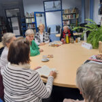 Członkowie Dyskusyjnego Klubu Książki w czytelni Biblioteki Publicznej w Miechowie podczas spotkania poświęconego powieści Zyty Rudzkiej »Ten się śmieje, kto ma zęby«.
